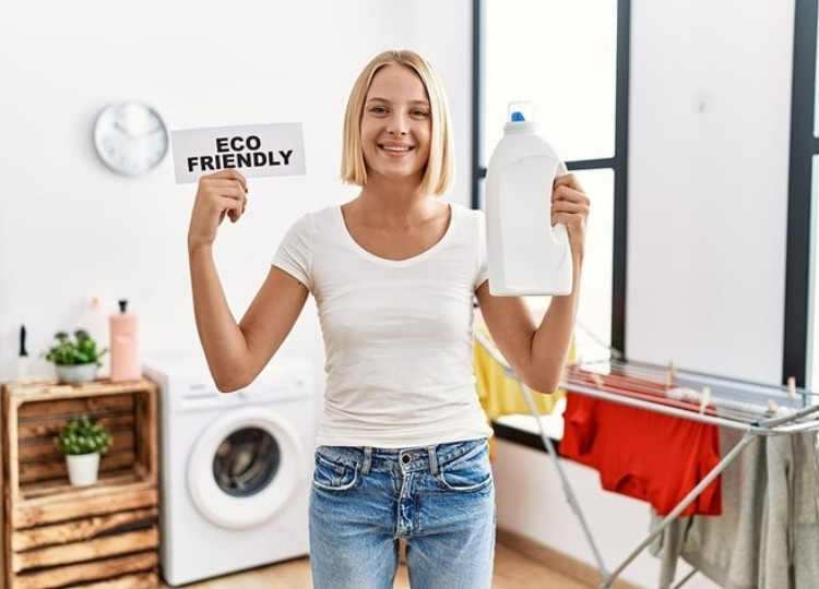 Woman doing laundry with natural detergent for eco-friendly plumbing